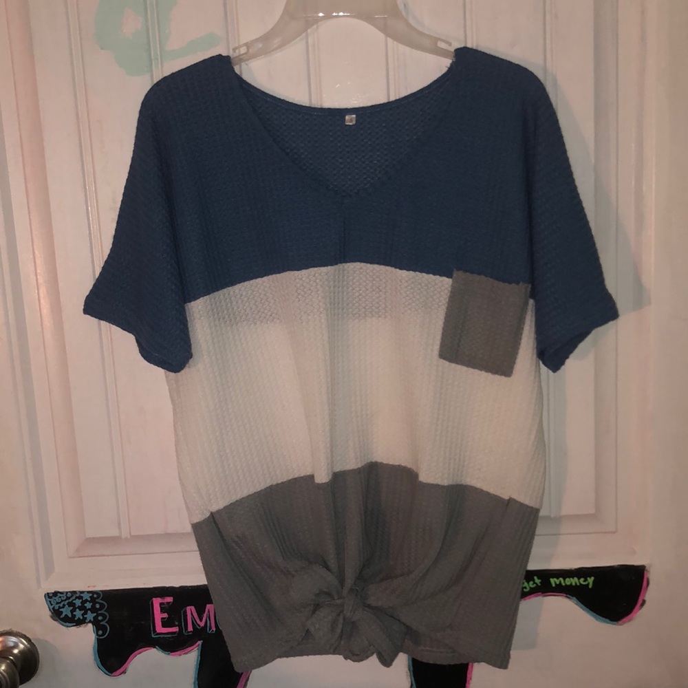 Short sleeve top with adjustable tie in the front.